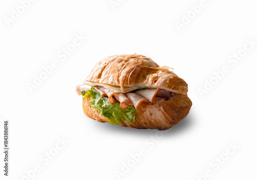 delicious and appetizing croissant sandwich with ham, cheese and lettuce isolated on white background