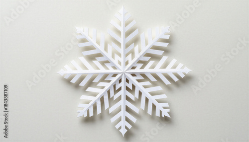 A single white paper snowflake on a textured off-white background, In What Style: Minimalist flat-lay photography with soft shadow, In What Colors: Pure white against warm beige backdrop, What It Repr