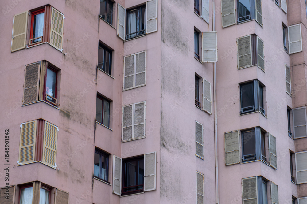 Fototapeta premium Residential Building Facade with Repeating Windows and Shutters