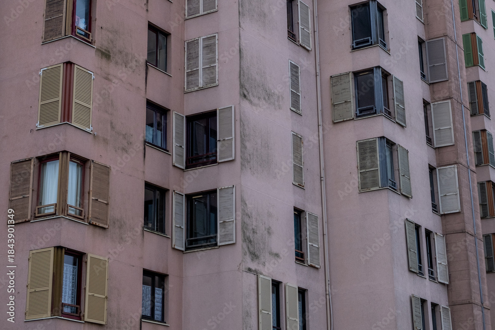 Fototapeta premium Residential Building Facade with Repeating Windows and Shutters