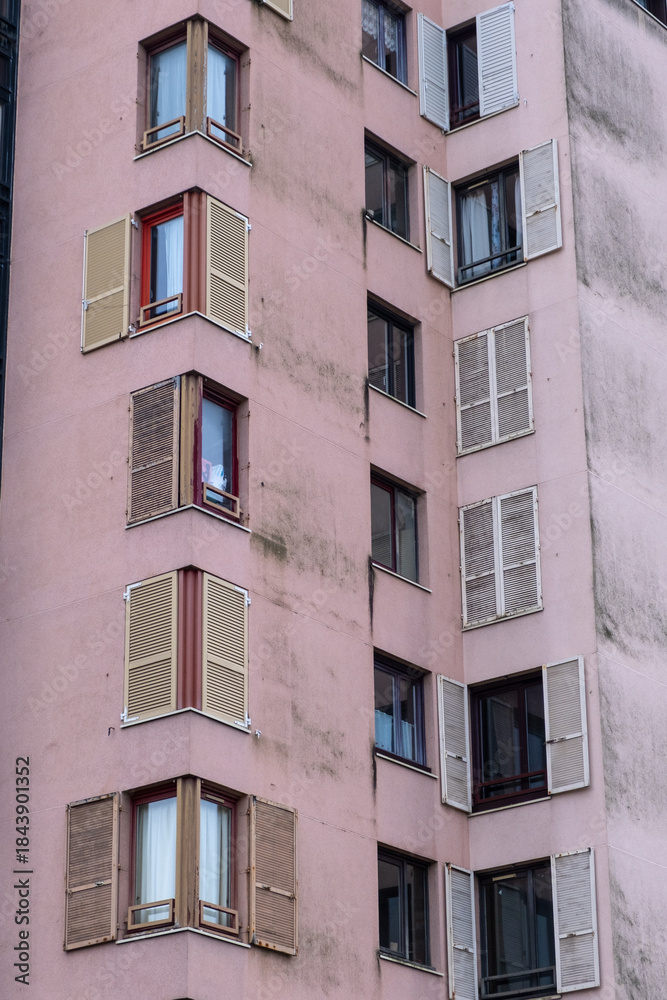 Fototapeta premium Residential Building Facade with Repeating Windows and Shutters
