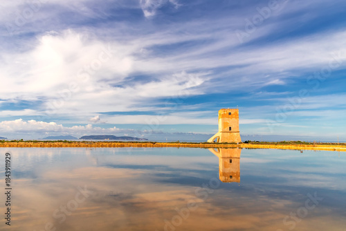 An incredibly serene and evocative scene featuring and salt tower standing in the middle of a vast, tranquil shallow body of water