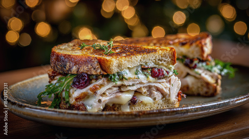 Gourmet Holiday Turkey and Cranberry Sandwich: Sourdough Bread with Melted Cheese, Sliced Turkey, Arugula, and Sweet Cranberry Relish on a Rustic Plate