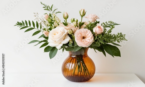 Wallpaper Mural Elegant floral arrangement with pale pink and cream roses in a ribbed amber glass vase against a white background. Torontodigital.ca