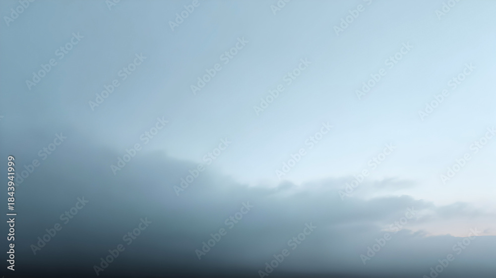 Naklejka premium Clear light blue sky transitions sharply into a dense band of moody gray clouds