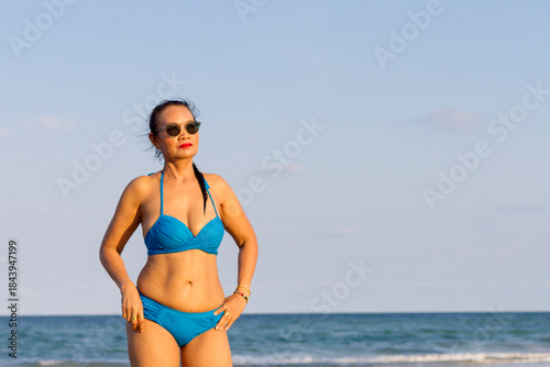 Woman in blue bikini show body pretty