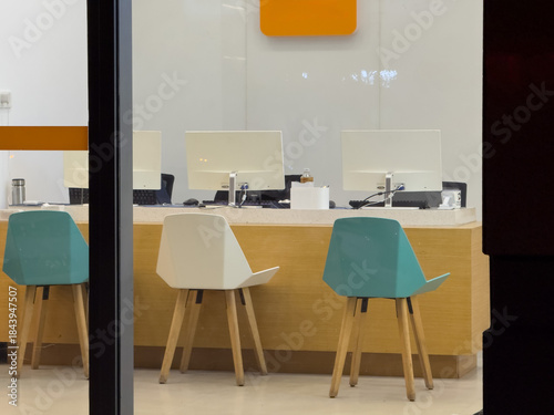 Modern Office Workspace with Colorful Chairs and Sleek Design for Creative Work Environments
