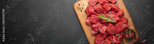 Obraz na plátně Diced cut raw beef cubes wooden cutting board red meat cooking protein top view