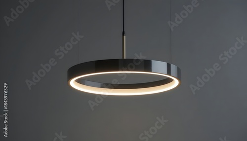 Stunning modern LED ring pendant light fixture illuminates dark minimalist interior space with elegant soft glow
