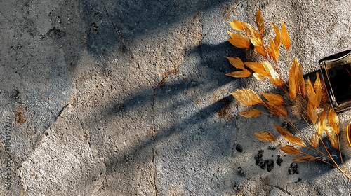 Golden dried branch next to dark perfume bottle on textured surface with sunset shadows. Generated with AI