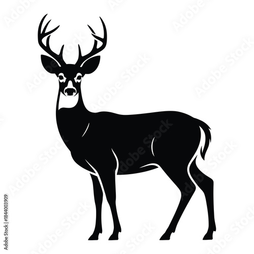 A striking black silhouette of a majestic buck with large antlers