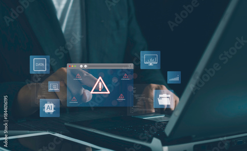 System warning alert, cyber risk detection, data error notification, AI monitoring interface shown through a business professional interacting laptop as digital warning icons appear on the screen.