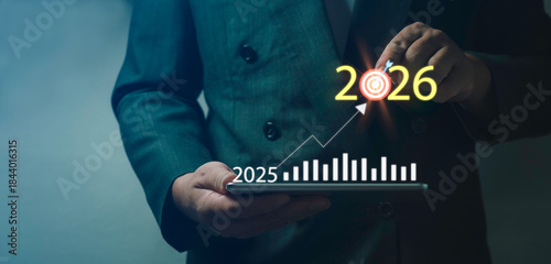 Future business targeting and strategic planning shown through businessman selecting digital goal for 2025 and 2026