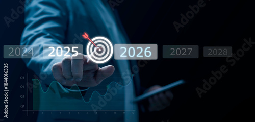 Businessman selecting digital target between 2025 and 2026 with futuristic data graphics, symbolizing goal setting, strategic planning, decision making