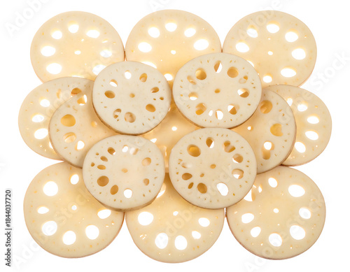 A collection of sliced lotus root pieces arranged in a circular pattern on a white background.