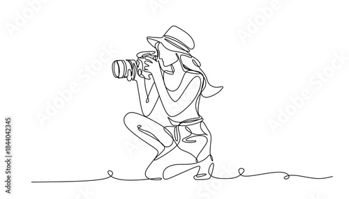 Continuous line drawing of a woman holding a camera up to her face taking a photograph in black and white