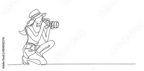 Continuous line drawing of a woman holding a camera up to her face taking a photograph in black and white