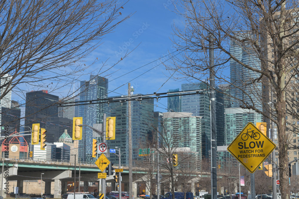 Naklejka premium crossing signs at Queens Quay W near Rees St looking northeast to buildings downtown, Toronto