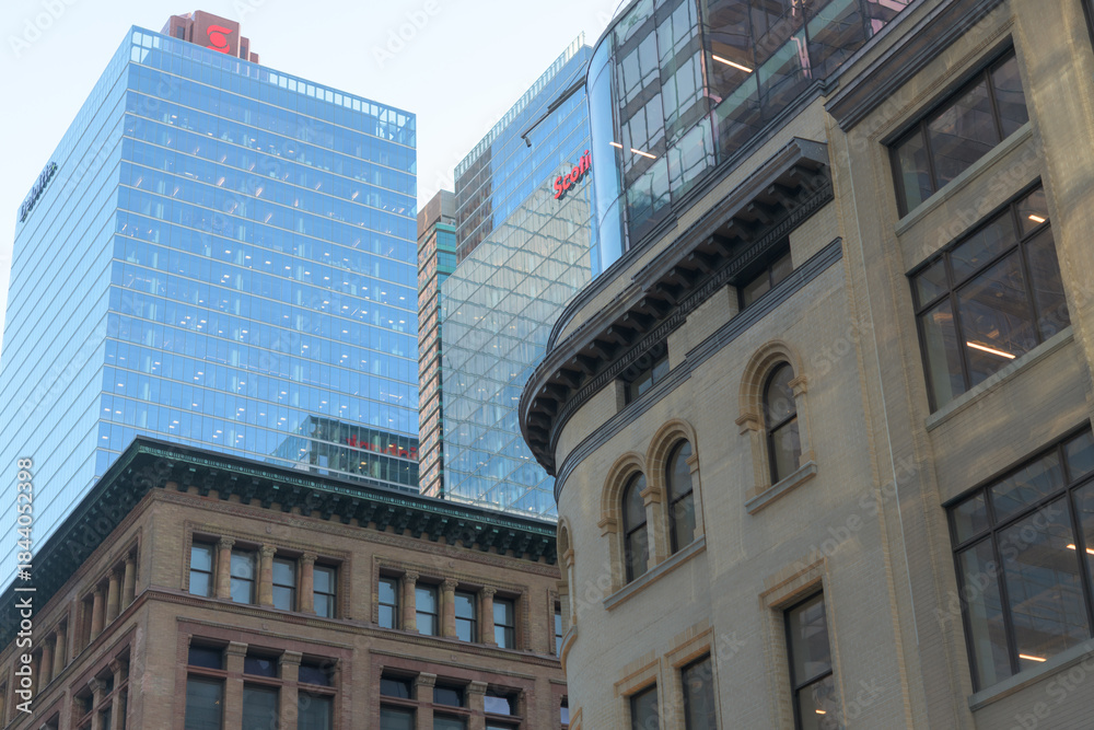 Fototapeta premium historic department store architecture at the north and south corner of Queen St W and Yonge St looking south to modern office buildings, Toronto