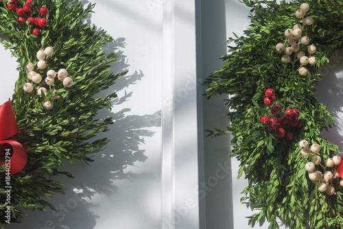 holiday wreaths on white doors