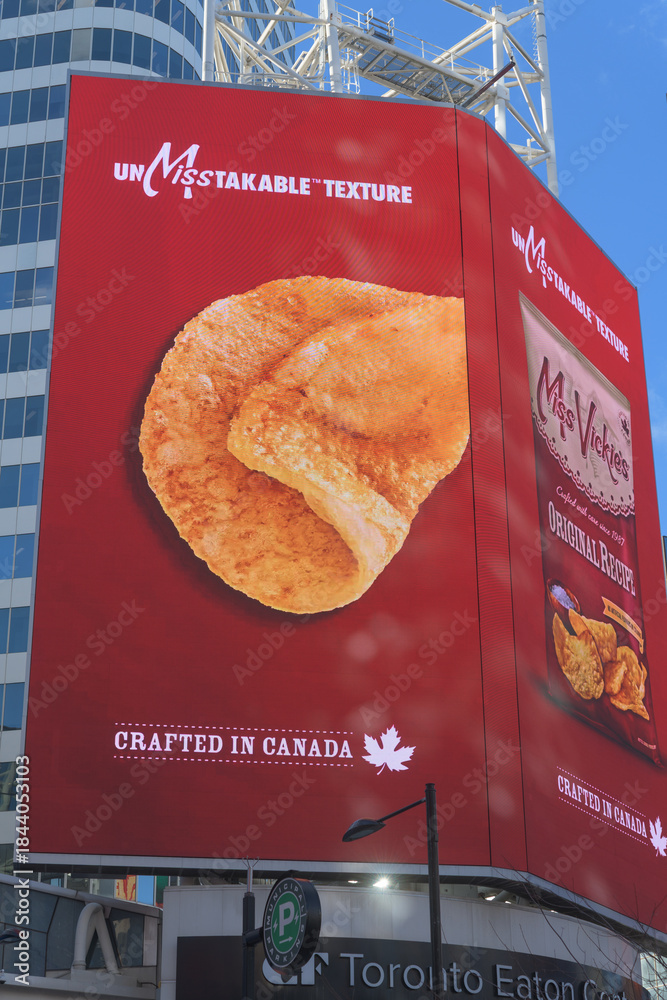 Fototapeta premium electronic sign featuring advertisement for Miss Vickie’s Original Recipe , a Canadian kettle-cooked potato chip brand (PepsiCo) near Sankofa Square, Toronto