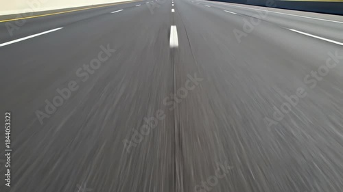Seamlessly looping abstract high speed view looking directly down at the yellow and white dashed lines of an empty interstate highway rapidly moving forward speed, geometry, graphics