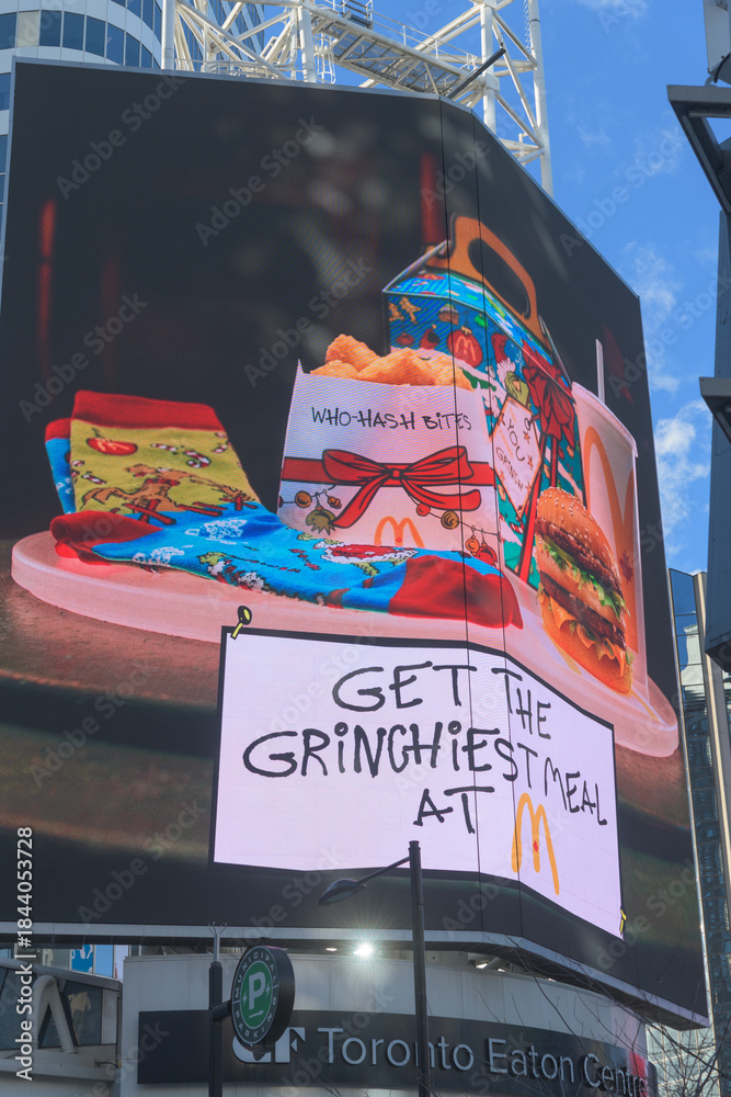 Naklejka premium McDonald's Canada holiday meal package featuring Grinchiest Meal, digital advertisement, facing Sankofa Square, Toronto