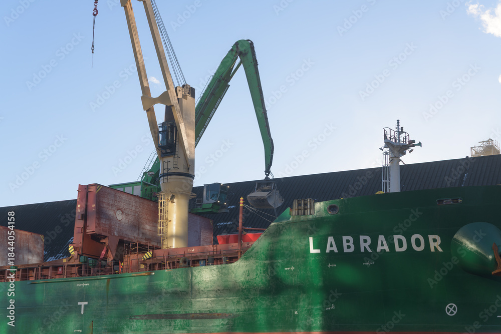 Naklejka premium view of Labrador, a bulk cargo carrier docked at Lower Jarvis Slip, next to Redpath Sugar Refinery, near 95 Queens Quay E, Toronto