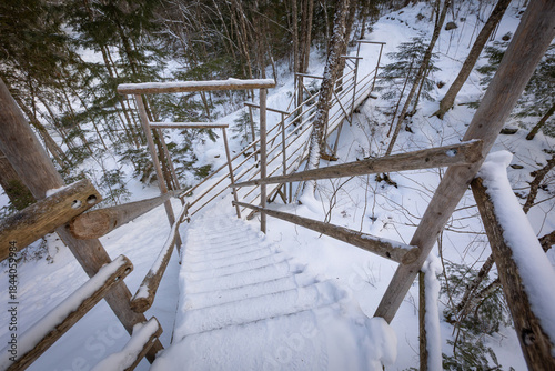 Snow covered steps leading down to hiking trail