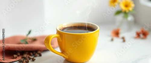 Steaming decaf coffee in a yellow cup on white, caffeine-free, hot