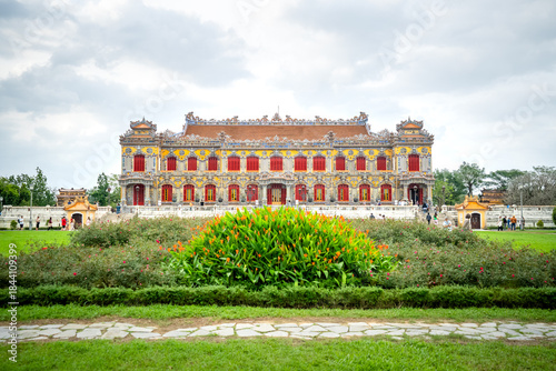Wallpaper Mural Vibrant Imperial Palace in Hue, Vietnam, showcasing intricate traditional architecture and lush green gardens under a cloudy sky. Torontodigital.ca