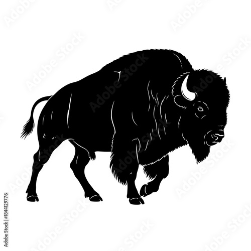 Black silhouette of a bison standing on a plain