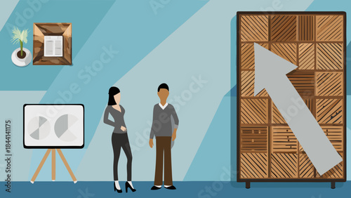 Two people standing in a room with a presentation board and a wooden arrow pointing upwards on wall