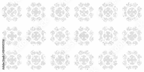 A repeating pattern of delicate floral like shapes in grayscale