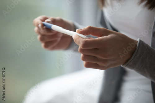 Home testing. Close up young female hands hold portable domestic stick pregnancy test. Family planning reproductive health early detection importance fertility ovulation ivf personal choice concept