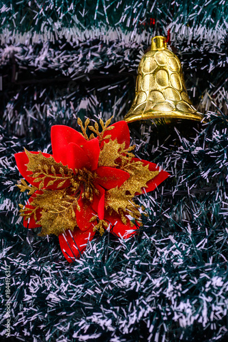 Close-up of a beautifully decorated ornament hanging on a artificial Christmas tree.