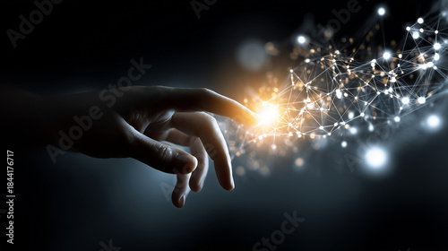 Hand Reaching Out to Touch a Digital Network Concept Representing Technology and Innovation with Glowing Nodes and Connections in Dark Background