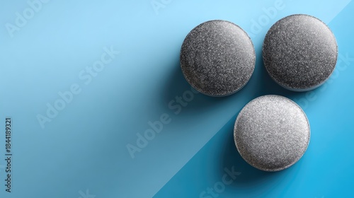 The focus is on a gray-white circular pill against a gradient background, with shadows on the pill. Pharmaceutical industry. Drugs. Vitamin and supplement concept. Gray-white pill texture on a blue ba