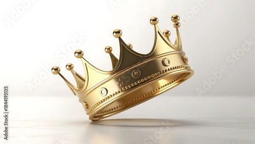 a gleaming golden crown rests slightly tilted on a smooth light gray surface casting a soft shadow showcasing regal splendor and power