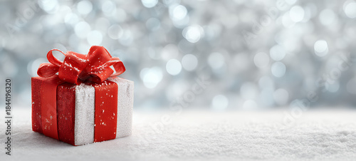 Cozy Christmas Gift Box with Red Ribbon on Wooden Table, Festive Golden Lights Background
