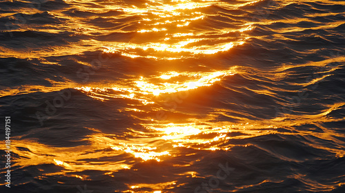 Golden evening light reflecting on sea surface tranquil seascape.
