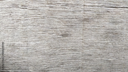 A close-up, detailed view of weathered, grey wooden planks with visible grain and texture.