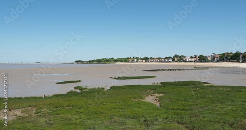 The large northern beach of Fouras-les-Bains in Charente-Maritime, followed by the fishing huts of Fouras, green wood and the Pointe d'Yves on the horizon

