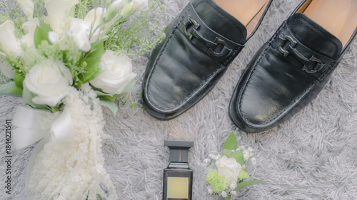 grooms shoes with hand bouquet decoration
