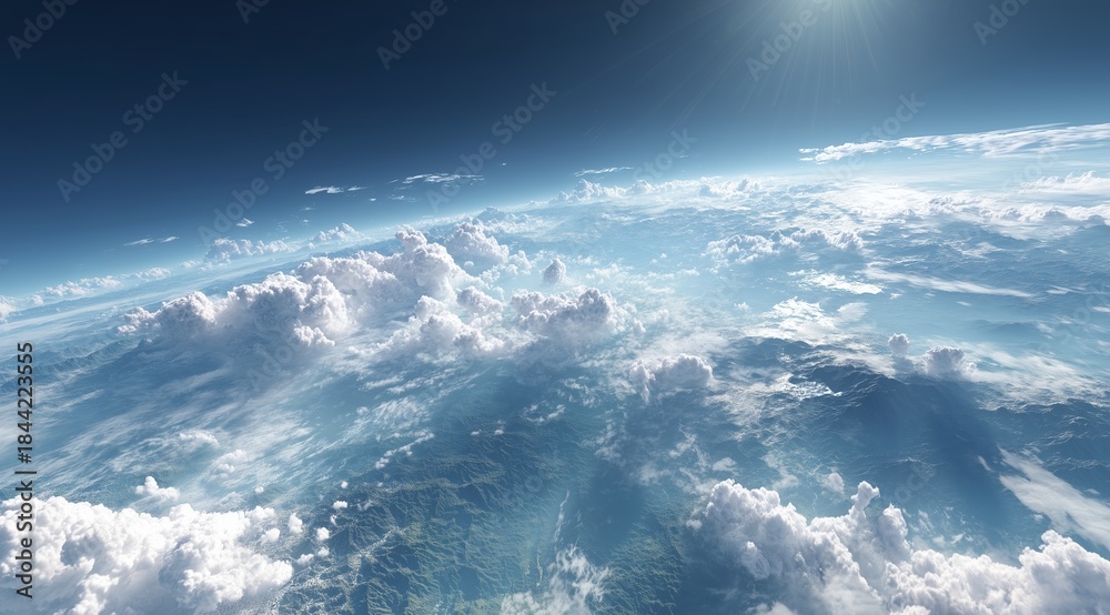 Naklejka premium Aerial View of Fluffy Cumulus Clouds Over Mountainous Terrain With Sunlight Rays and Settlements
