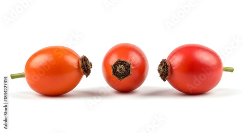 Three vibrant rose hips, arranged in a row, isolated on a white backdrop, perfect for illustrating