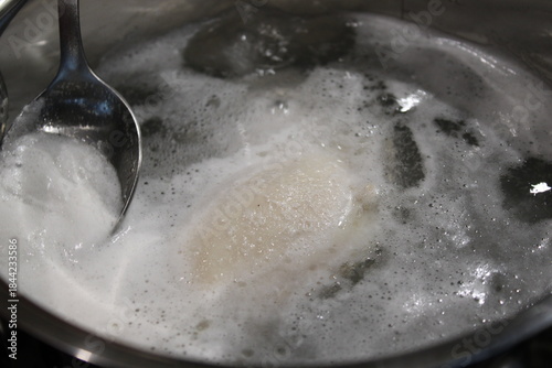 Cooking dough in boiling water during food preparation at home in the evening