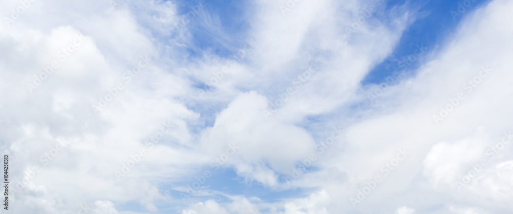 Obraz premium Clear blue sky filled with soft white clouds creates a calm, peaceful atmosphere