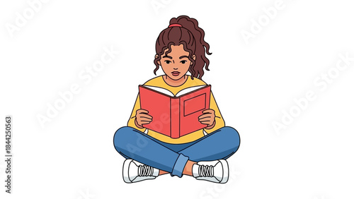 Young woman engrossed in reading a book while sitting cross-legged