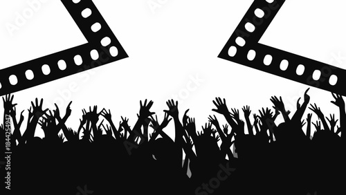 A crowd of silhouetted people with hands raised under spotlight beams